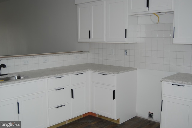 835 Bennett St, Wilmington, DE 19801 - kitchen with decorative backsplash, light countertops, white cabinets, and dark wood-style flooring