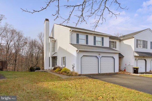 view of front of house with a garage and a front lawn