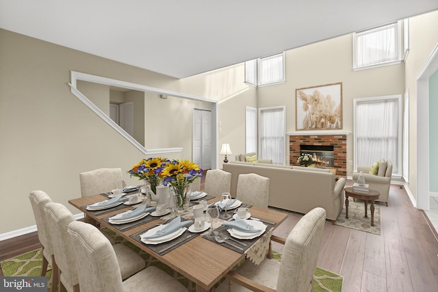 dining room with a fireplace and hardwood / wood-style floors