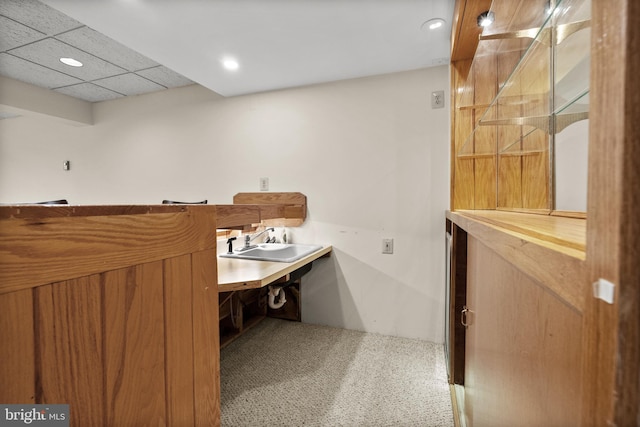 bathroom with a paneled ceiling and sink