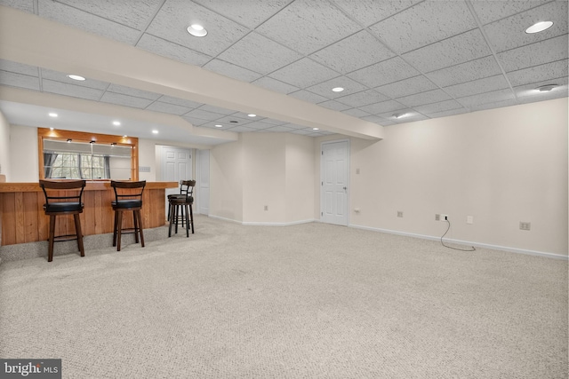 bar with carpet flooring and a drop ceiling