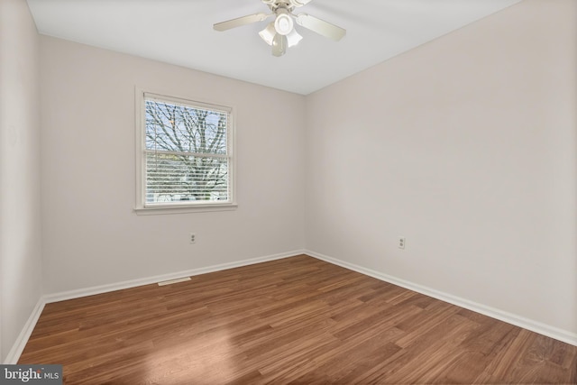 unfurnished room with hardwood / wood-style flooring and ceiling fan