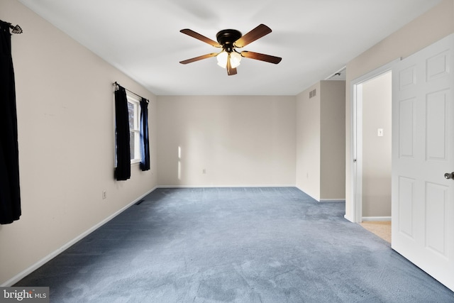 carpeted spare room featuring ceiling fan