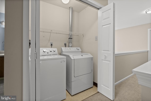 clothes washing area featuring washer and dryer