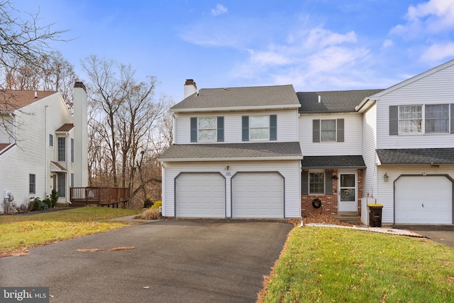 view of front of home with a front lawn and a garage