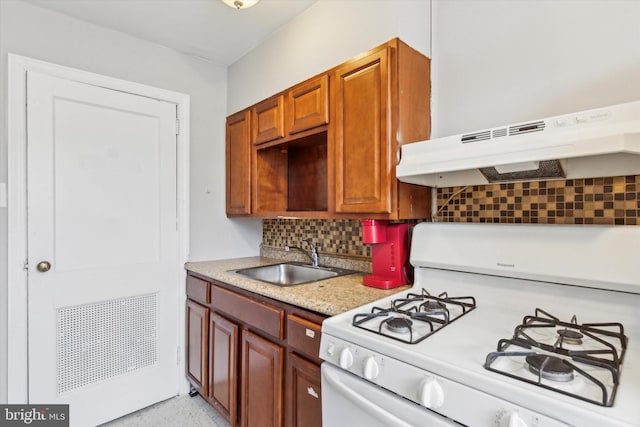 kitchen featuring tasteful backsplash, extractor fan, white gas stove, and sink