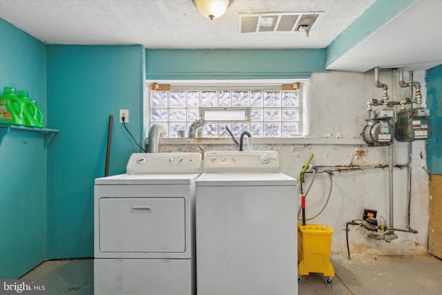 clothes washing area with washing machine and clothes dryer