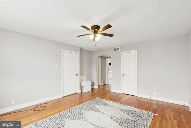 spare room with hardwood / wood-style floors, a textured ceiling, and ceiling fan