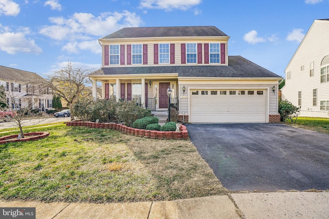 view of front of home featuring a front yard and a garage