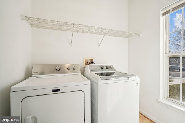 laundry area featuring independent washer and dryer and plenty of natural light