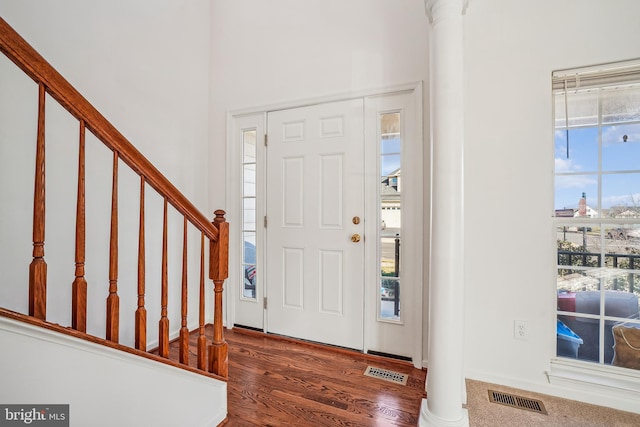 entrance foyer with dark hardwood / wood-style flooring and ornate columns