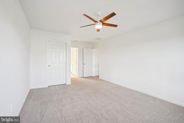 unfurnished room featuring ceiling fan and light colored carpet