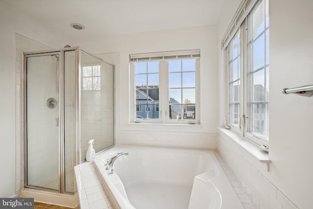 bathroom featuring separate shower and tub