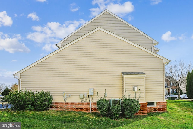 view of property exterior with a yard and central AC