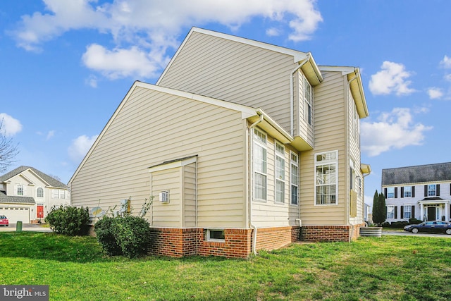 view of side of home featuring a lawn