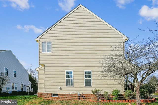 view of side of home featuring a lawn