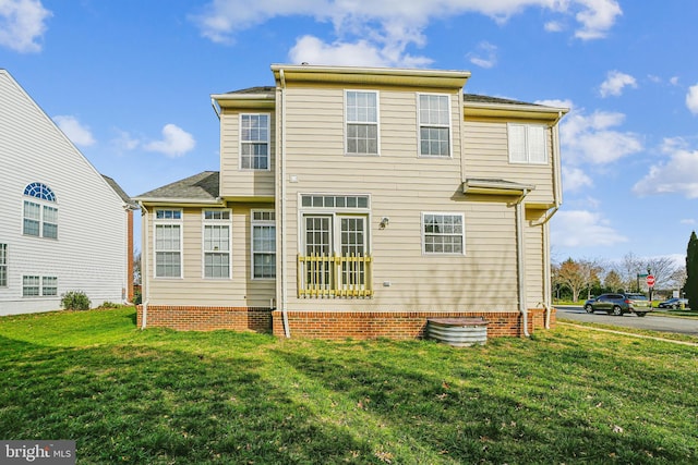 rear view of property featuring a yard