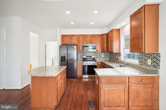 kitchen with decorative backsplash, appliances with stainless steel finishes, dark hardwood / wood-style floors, and sink