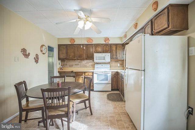 kitchen with decorative backsplash, white appliances, and ceiling fan