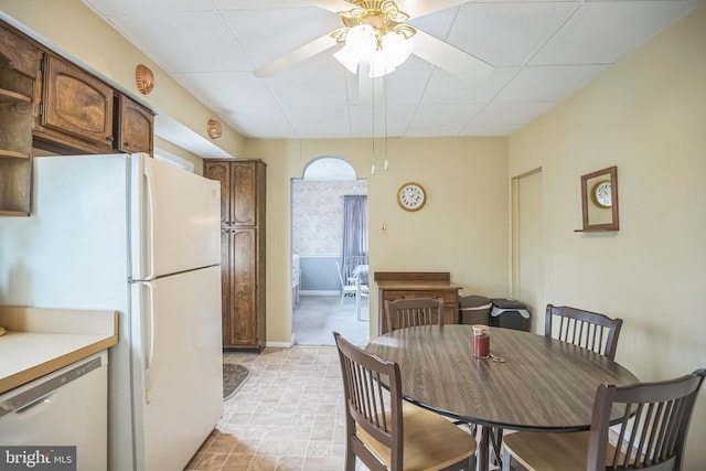 dining space featuring a drop ceiling and ceiling fan