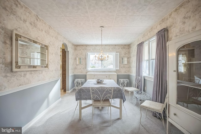 dining room featuring carpet flooring and a notable chandelier