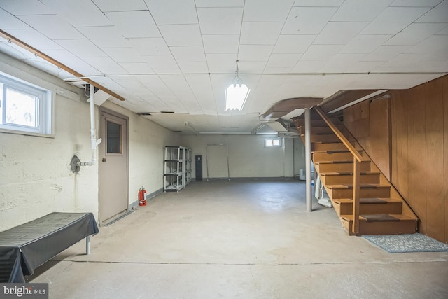 basement featuring wooden walls