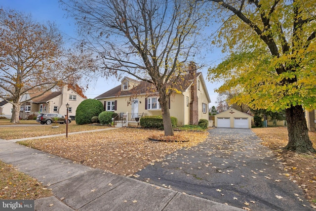 view of front of house featuring a garage and an outdoor structure