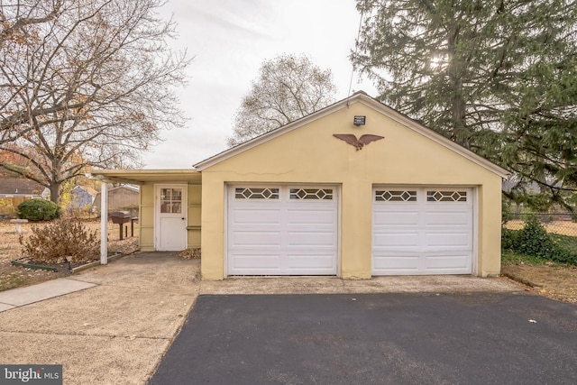 view of front of house featuring a garage and an outdoor structure