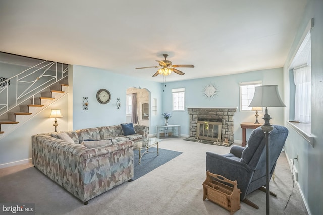 carpeted living room featuring ceiling fan