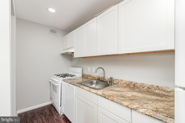 kitchen featuring white appliances, sink, light stone countertops, dark hardwood / wood-style flooring, and white cabinetry