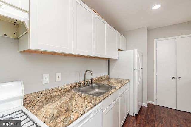 kitchen with white cabinets, dark hardwood / wood-style floors, white appliances, and sink