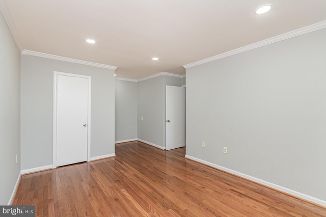 unfurnished room with hardwood / wood-style floors and ornamental molding