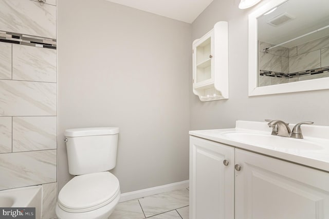 bathroom featuring vanity and toilet