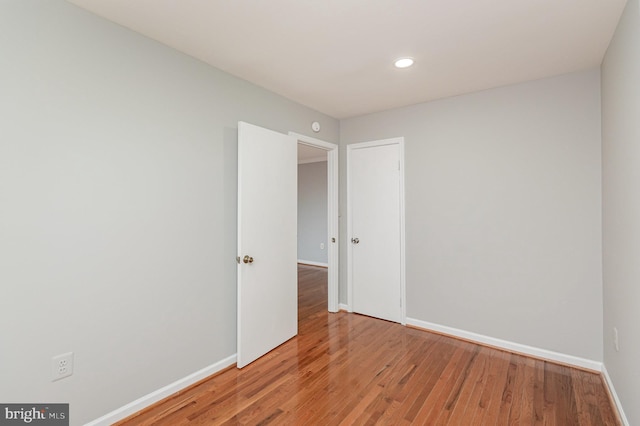 unfurnished room featuring hardwood / wood-style flooring