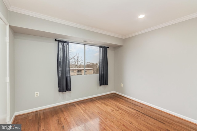 unfurnished room with hardwood / wood-style floors and crown molding