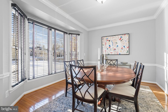 dining area featuring ornamental molding and light hardwood / wood-style floors