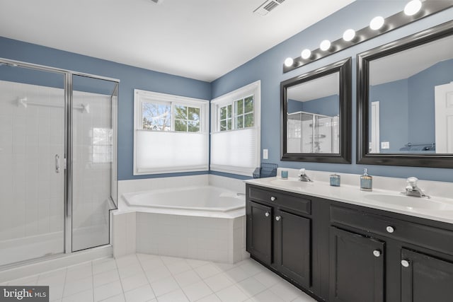 bathroom featuring independent shower and bath, tile patterned floors, and vanity