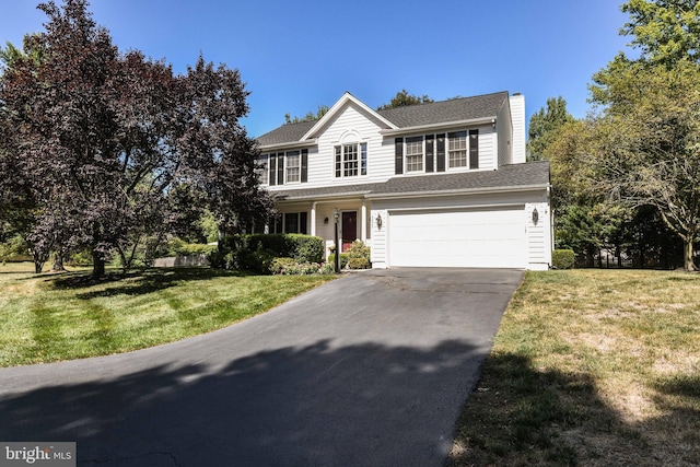 view of front of house with a front lawn and a garage