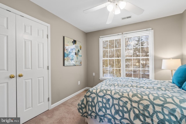 bedroom featuring a closet, ceiling fan, and light colored carpet