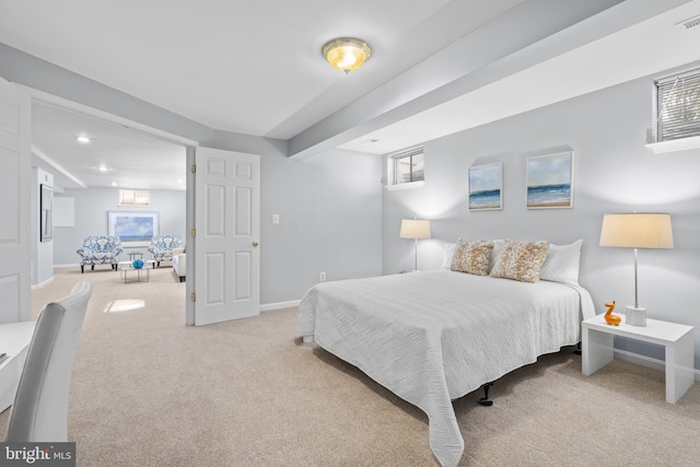 bedroom with light colored carpet and multiple windows