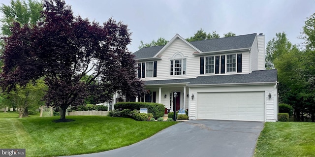 view of front of home featuring a front yard and a garage