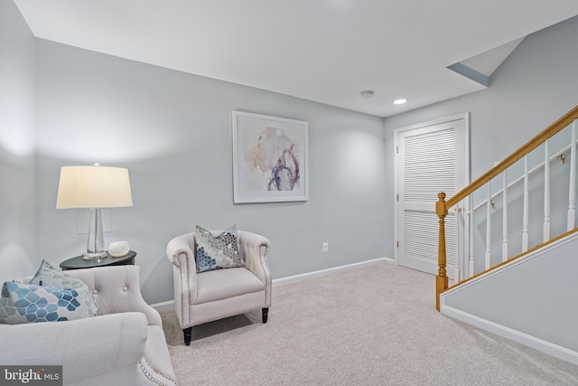 sitting room featuring light carpet