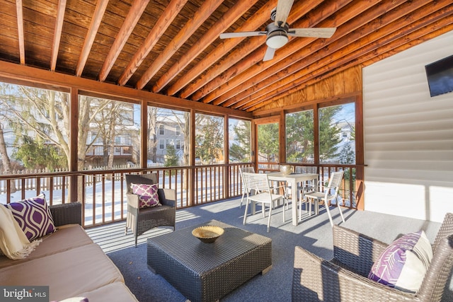 sunroom / solarium featuring ceiling fan, wood ceiling, and vaulted ceiling with beams