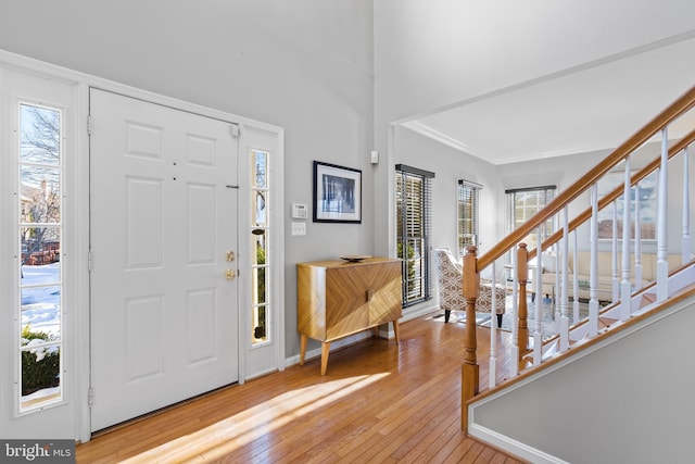 foyer featuring hardwood / wood-style floors and crown molding