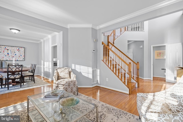 living room featuring ornamental molding and wood-type flooring