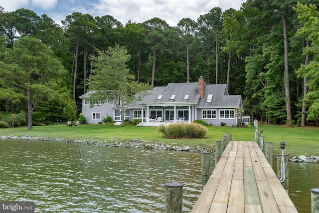 dock area featuring a water view and a lawn