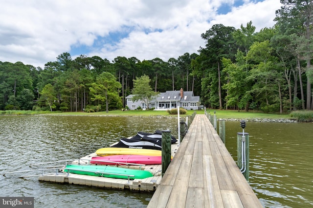 dock area with a water view and a wooded view