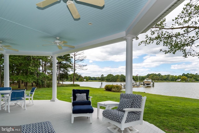 view of patio with a water view and a ceiling fan