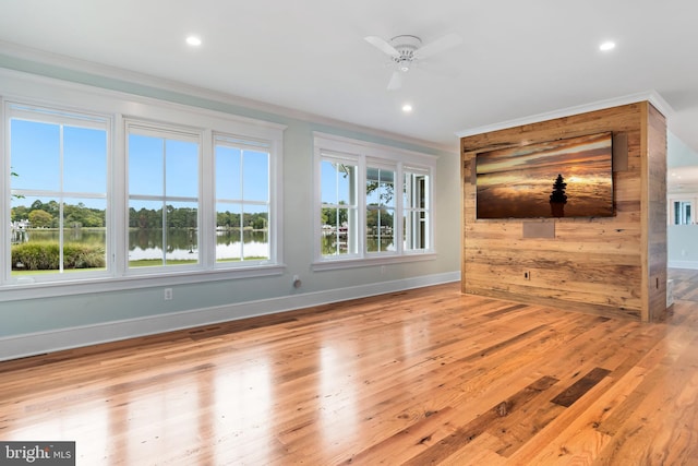 unfurnished living room featuring plenty of natural light, wood finished floors, and recessed lighting