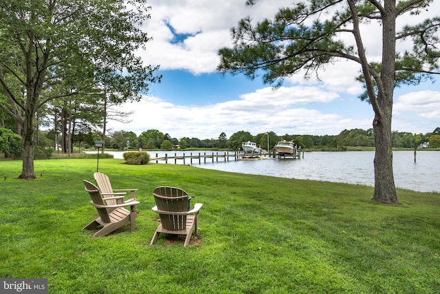 view of yard featuring a boat dock and a water view